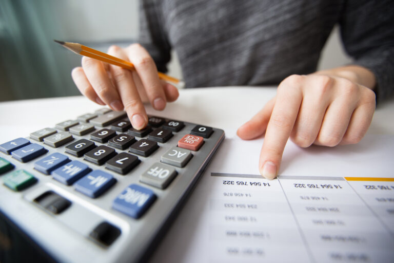 Person calculating small business accounting expenses